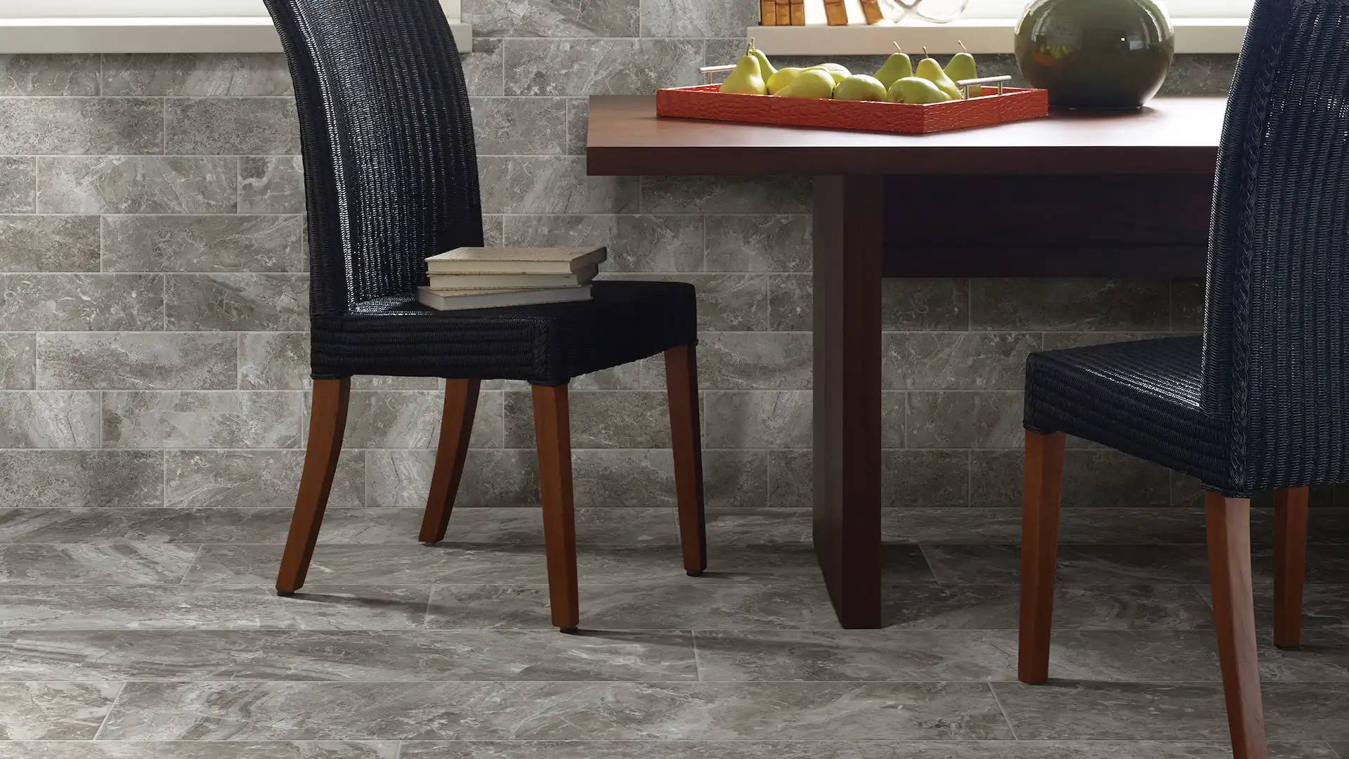 commercial flooring photo, 2 black chairs, wooden table, fruit on table
